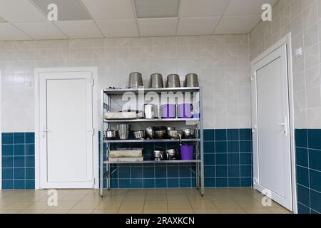 Industrial kitchen in a school restaurant with professional equipment and pans Stock Photo