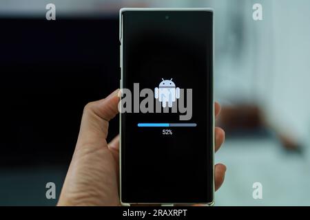 Krakow, Malopolska, Poland - September 2021: Android phone update installing, loading screen, smartphone display closeup. Updating mobile device Stock Photo