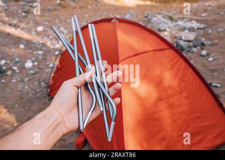 Aluminum frame arcs for the installation of a hiking tent in the hand. Lightweight equipment for travel and trekking. Outdoor activity and recreation Stock Photo