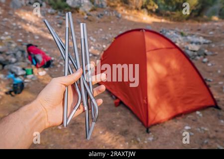Aluminum frame arcs for the installation of a hiking tent in the hand. Lightweight equipment for travel and trekking. Outdoor activity and recreation Stock Photo