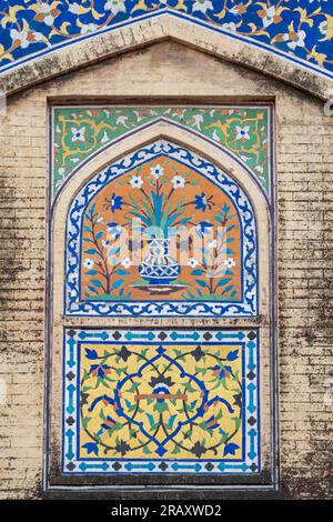 Beautiful colorful kashi-kari or faience tile mosaic design on ancient mughal era Wazir Khan mosque in the walled city of Lahore, Punjab, Pakistan Stock Photo