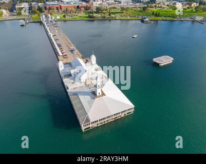 Aerial view of a tower atop a pavilion on the end of a long pier out over a calm bay at Geelong in Victoria, Australia Stock Photo