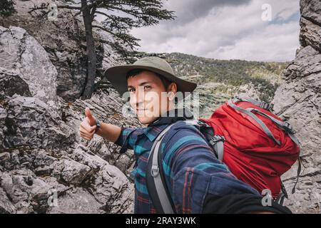 Happy man traveler naturalist against the backdrop of a Lycian way in the woods and mountain landscape background Stock Photo