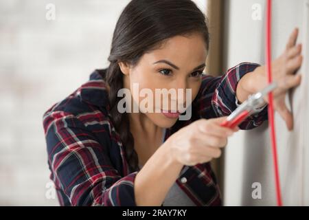 young focused woman electrician wiring Stock Photo