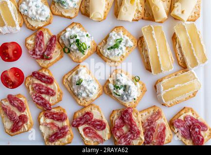 Platter with crackers on white background from above Stock Photo