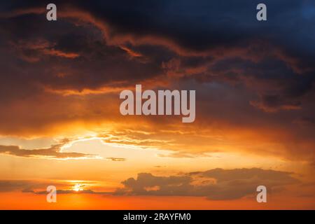 Dramatic sky with storm clouds during sunset. Summer stormy weather Stock Photo