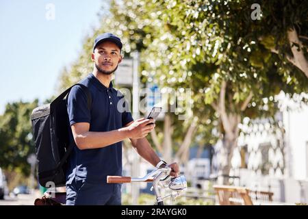 Bicycle, phone and delivery service by man use maps on smartphone to navigate city for package, product or fast food. Bike, mobile app and courier Stock Photo