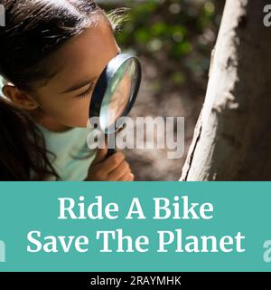 Composition of ride a bike save the planet text over biracial girl with magnifying glass by tree Stock Photo