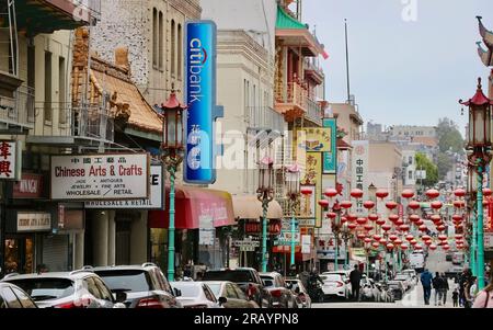 View along Grant Avenue with a Citibank sign and hanging Chinese lanterns Chinatown San Francisco California USA Stock Photo