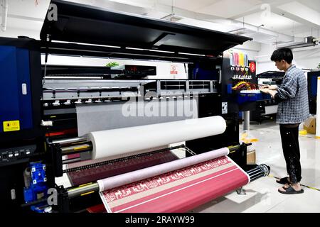 Caoxian, China's Shandong Province. 6th July, 2023. A staff member works at a Hanfu-related factory in Caoxian, east China's Shandong Province, July 6, 2023. Caoxian County has developed a complete Hanfu industrial chain in recent years. At present, there are more than 2,100 Hanfu-related enterprises in the county. The sales of Hanfu in Caoxian reached nearly 4 billion yuan (about 552 million U.S. dollars) in the first half of this year. Credit: Guo Xulei/Xinhua/Alamy Live News Stock Photo