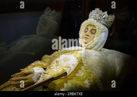 Guadalest, Alicante, Spain - January 14, 2023: Sculpture of a religious saint possible Virgin Mary inside a Catholic Church. The figure is crowned wit Stock Photo