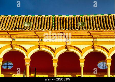 Seville, Spain - January 20, 2023:  Close-up of arches and the rooftop with clay tiles. Stock Photo