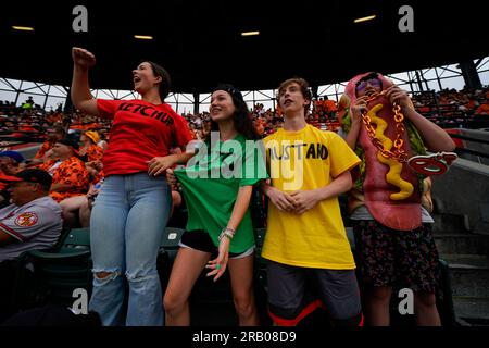 Siblings, from left, Olivia Nerad, Brooke Conger, Charles Nerad, John  Conger react after watching the Hot Dog Race on the big screen at Oriole  Park at Camden Yards during the fifth inning