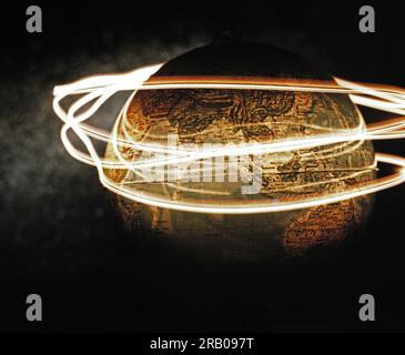 Light streaks encircling globe Stock Photo