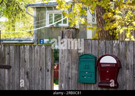 Mailboxes on the fence of a private house in the countryside, a cozy suburban area Stock Photo