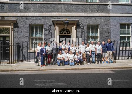 London UK. 6 July 2023 . Journalist Mike McCarthy holds the 'Baton of Hope' as it is delivered to number 10, Downing Street The baton has toured 12 cities across the UK, starting in Glasgow on Sunday 25th June and culminating in Downing Street today to highlight the suicide rate  that sees 17 people take their own lives every day in the UK.   Credit amer ghazzal/Alamy Live News Stock Photo