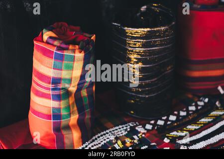 Upright roll of handwoven T'boli Malong "tube skirt" in traditional colors and design in red plaid which can be worn as dress, skirt, cape, etc. Stock Photo