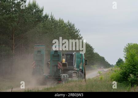 Between Jüterbog and Felgentreu, June 6 2023, Germany, large forest fire for days on the former military site, which is now a nature reserve, a large excavator is delivered to fight the fire Stock Photo