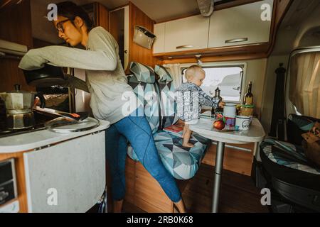 Family having breakfast in camper Stock Photo