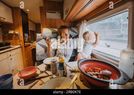 Family having breakfast in camper Stock Photo