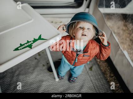 Little girl playing with a bowl on her head Stock Photo