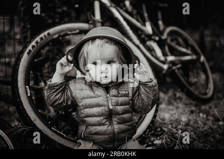 Little girl playing with a bowl on her head Stock Photo