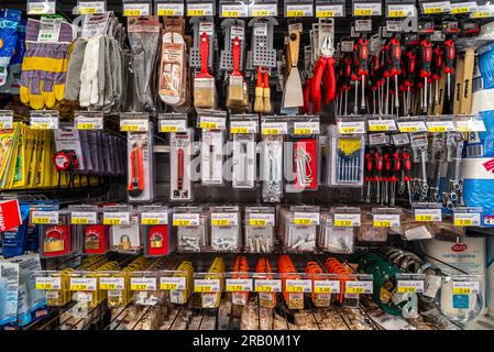 Italy - July 06, 2023: Various repair tools for sale on shelves hardware store in supermercato italiano. Stock Photo