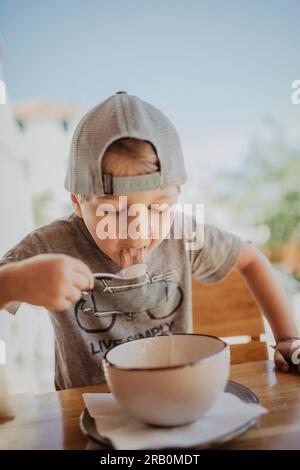 Little boy eating a bowl of semolina porridge Stock Photo