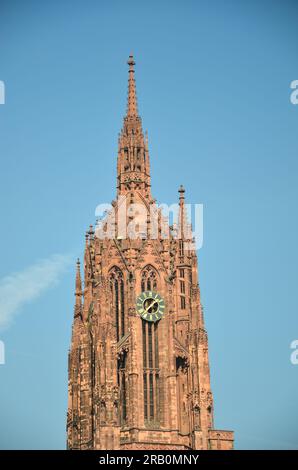 Red tower with big clock of the imperial cathedral St. Bartholomäus in Frankfurt am Main under blue sky Stock Photo