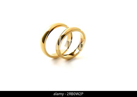 Detail of engagement gold rings standing parallel next to each other isolated on white isolated background. Elevated view. Stock Photo