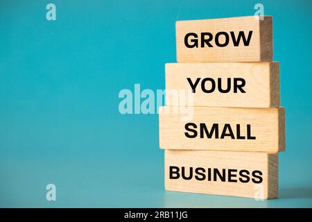 Grow Your Small Business, Written on Wooden Boards, Business Concept, Small Business Support, Copy Space, beautiful blue Background Stock Photo