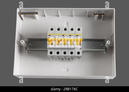 Plastic distribution board. Electrical board. Close-up. Isolated on light gray background. Stock Photo