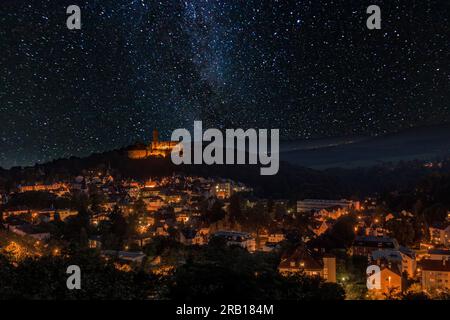 Night shot of Königstein with castle ruins In the forest, view above the village into the starry sky, at night, Taunus, Hesse, Germany Stock Photo