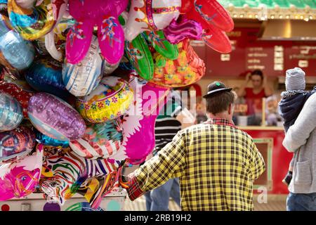 A balloon seller in a clown costume Stock Photo