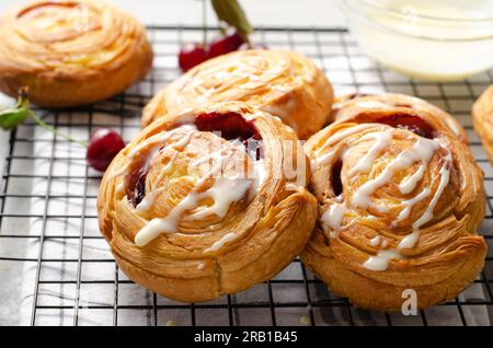 Freshly Baked Puff Pastry with Cherries on Bright Light Grey Background Stock Photo