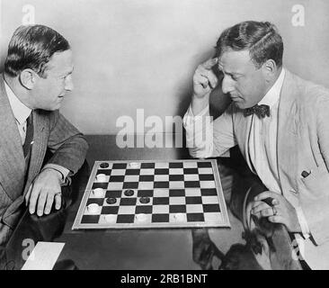 New York, New York:  September 1, 1931 'Gentleman Jack' O'Brien (left} former welterweigth champion, author, vaudeville performer and inventor of the chess 'master move', shows it off to Harry Chesterfield, secretary of the National Vaudevile Artistes. Stock Photo