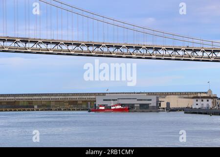 SFFD Phoenix Fireboat Number 1 moored at floating fire station 35 Pier 22 1/2 and Bay Bridge The Embarcadero San Francisco California USA Stock Photo