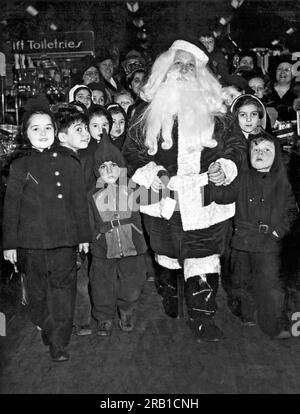 Union City, New Jersey:  December 8, 1942. This mother of eight is filling in for the regular Christmas Santa who is filling in on factory war work. Stock Photo