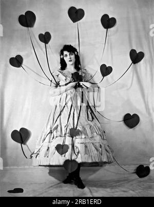 Hollywood, California:  c. 1925. Jacqueline Logan (1901-1983, silent film star, holding the multitude of hearts given to her on St. Valentine's Day. They all came with strings attached. Stock Photo