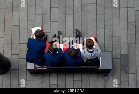 Four male middle-school students working together on a geography project in Liverpool Stock Photo