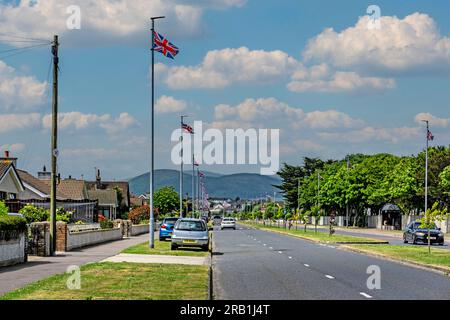 Union Jack flags hang from every lamppost in  Knockchree Avenue, Kilkeel, County Down, Northern Ireland, following the coronation of King Charles. Stock Photo