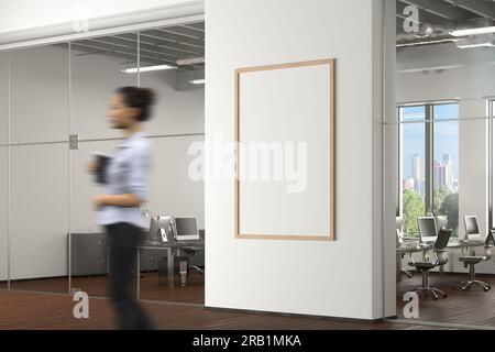 Blank vertical poster mock up on the white wall in office interior Stock Photo