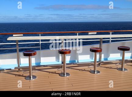 A row of bar stools with a sea view on the TUI Group cruise ship Marella Explorer Stock Photo