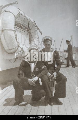 Two electrical ratings with Second World War medal ribbons on board the light cruiser HMS Liverpool c. 1945-1952. Stock Photo