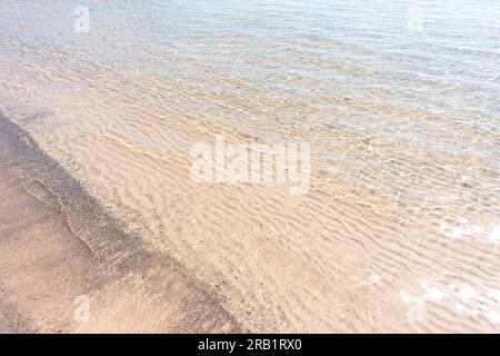 White sand beach with clear blue transparent water in summer sun for a paradise vacation and holiday concept Stock Photo