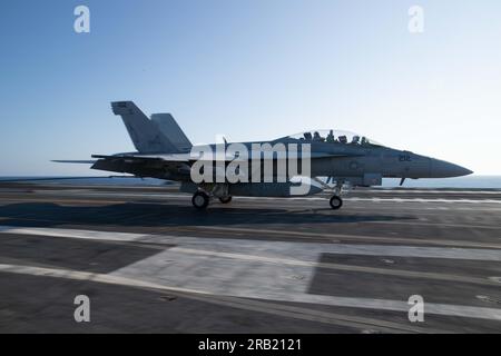 An F/A-18E Super Hornet, attached to the ÒBlacklionsÓ of Strike Fighter Squadron (VFA) 37, lands on the flight deck of the worldÕs largest aircraft carrier USS Gerald R. Ford (CVN 78), July 5, 2023. VFA 37 is deployed aboard CVN 78 as part of Carrier Air Wing (CVW) 8. Gerald R. Ford is the U.S. NavyÕs newest and most advanced aircraft carrier, representing a generational leap in the U.S. NavyÕs capacity to project power on a global scale. The Gerald R. Ford Carrier Strike Group is on a scheduled deployment in the U.S. Naval Forces Europe area of operations, employed by U.S. Sixth Fleet to defe Stock Photo