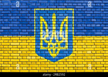 Coat of Arms of Ukraine painted on brick wall Stock Photo