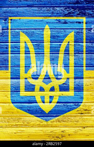Coat of Arms of Ukraine painted on wooden wall Stock Photo