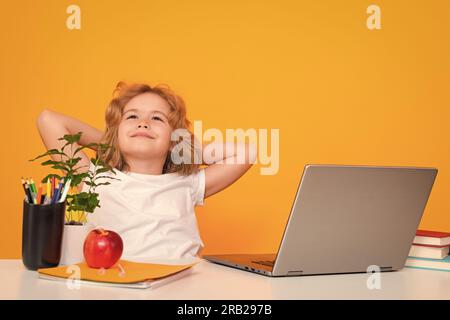 School child using laptop computer. School kid student learning, study language or literature at school. Elementary school child. Portrait of nerd pup Stock Photo