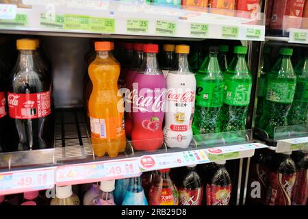 Assorted Coca-Cola flavors and varieties on display on a refrigerated rack at a Family Mart in Taipei, Taiwan; Diet, Cherry, Coke Zero, Sprite, Fanta. Stock Photo